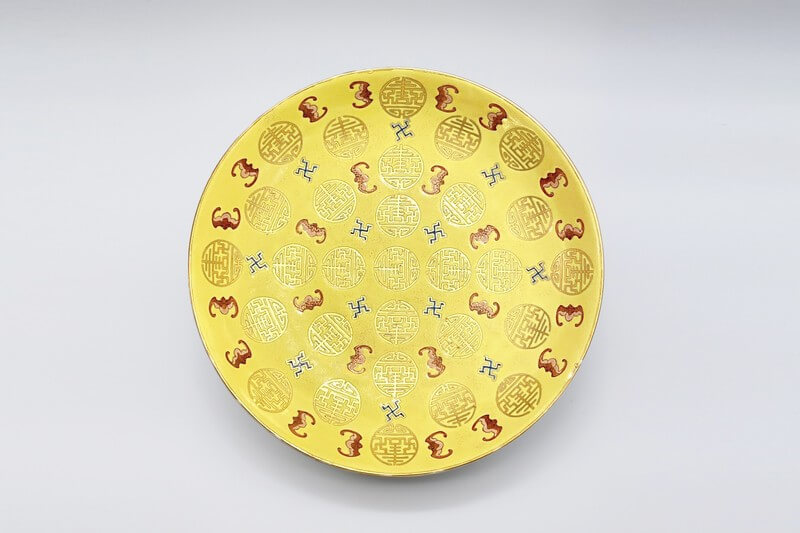A good and rare yellow ground famille rose ‘Longevity’ dish 