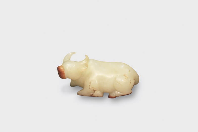 A fine and rare white jade carving of a recumbent ox